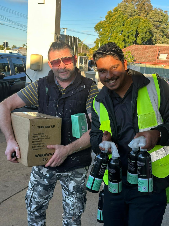 Happy customer with a WakaWax waterless car-wash bottle
