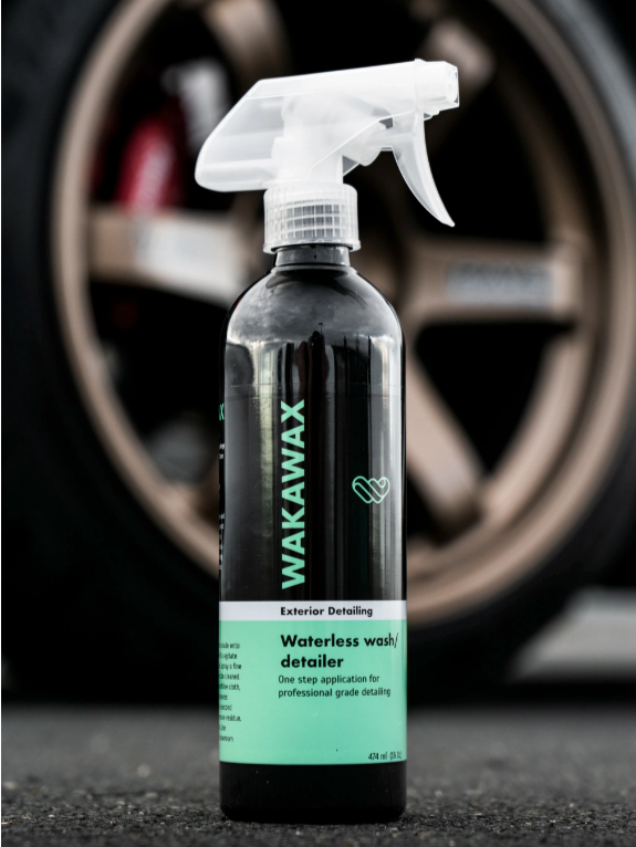 WakaWax Waterless Car Wash 750ml bottle beside a car wheel