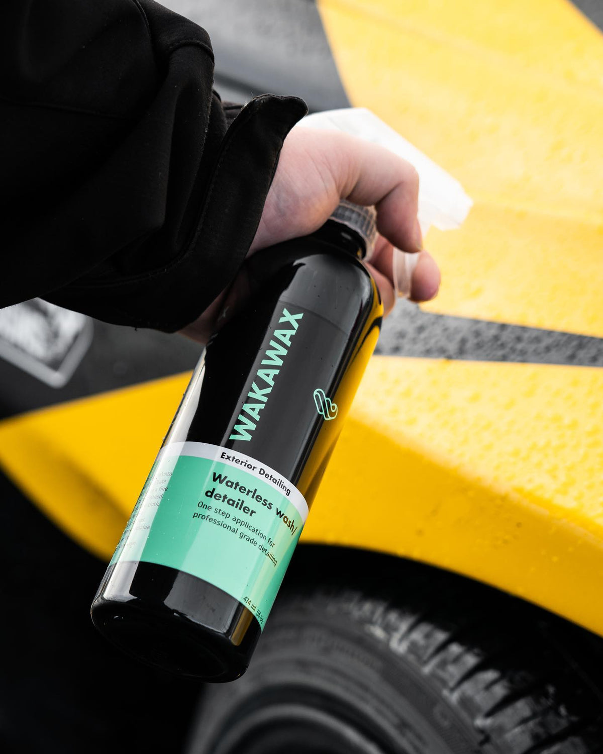 Applying WakaWax waterless car wash to a yellow car exterior